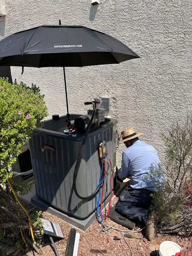 HVAC technician performing outdoor AC maintenance in East Highland Park
